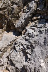A close up of the surface of the grey stone.Close-up of a rocky cliff. Stones. Background.