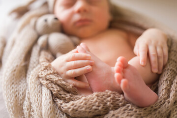 Beautiful conceptual image of Maternity. Little baby feet in mother hands, closeup