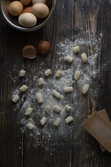 Italian traditional potatoes gnocchi on a wooden background. 