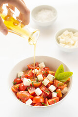 Greek village salad horiatiki with feta cheese, olives, cherry tomato, cucumber and red onion, vegeterian mediterranean food, low calories dieting meal