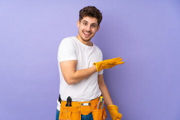 Young electrician man over isolated on purple background extending hands to the side for inviting to come