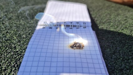 burning fire on a sheet of paper