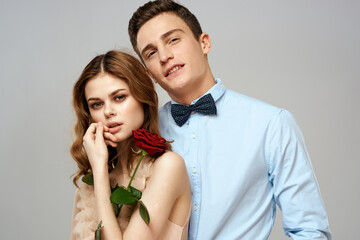 Young couple romance hug relationship dating red rose light studio background