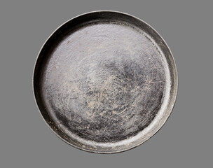Old black cast iron Frying pan isolated on grey background top view close-up