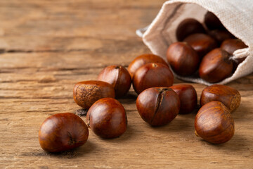 Heap of Roasted chestnuts on wooden background