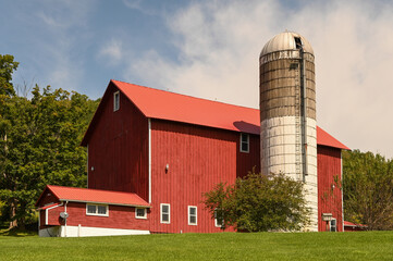 Red barn with silo in upstate New York. Season is summer. © Ann