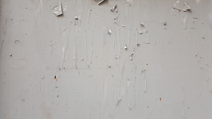 wood plywood wall painted white with bill removed with paper rips and staples