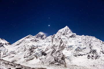 Mount Everest under bright stars. Everest base camp on clear starry night. View from the trail to...