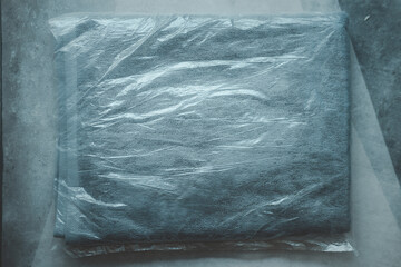 Gray Towel in package after wash ready to use for guest in hotel