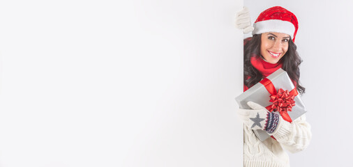 Christmas dressed female behind a white board with space for a sign