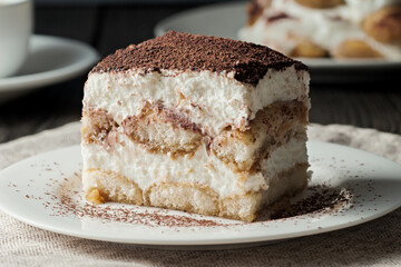 Delicious traditional tiramisu cake on a plate.