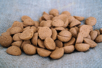 Dutch holiday Sinterklaas background with kruidnoten, traditional Sinterklaas sweets.. Pepernoten on sacking for sweets and gift boxes. Concept for children party Saint Nicolas day five december