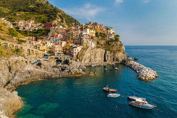 Fantastic panoramic view of the Manarola marina with anchored boats and the old colourful houses on...
