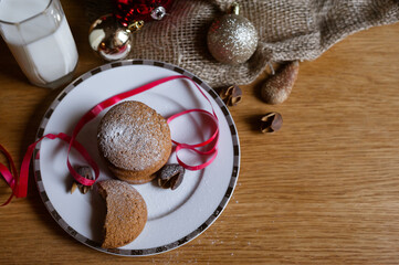 Delicious homemade Christmas cookies on a light plate, close-up view. Beautiful composition with Christmas cookies and milk. Top view with copy space.