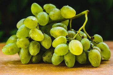 bunch of grapes on the wooden table