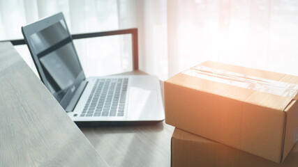 Parcel box on desk with laptop at workplace. Business at home concept. Business start up SME concept.