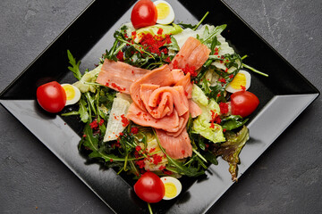Fresh seafood salad served with salmon and red caviar