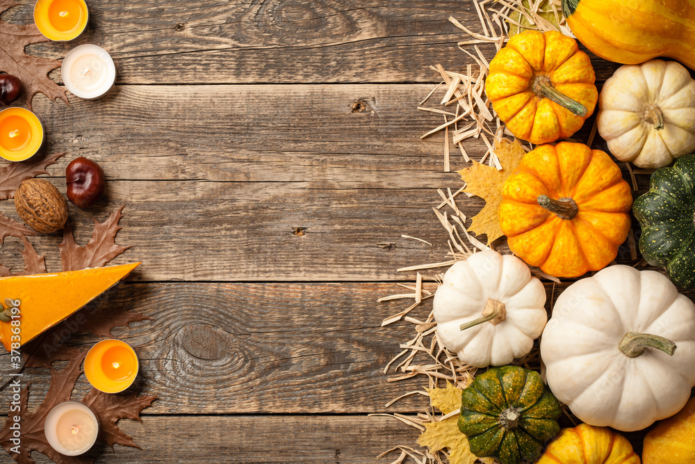 Poster Thanksgiving background with decorative pumpkins, pumpkin pies and candles