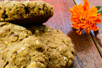 homemade oatmeal cookies with flower on wooden table 