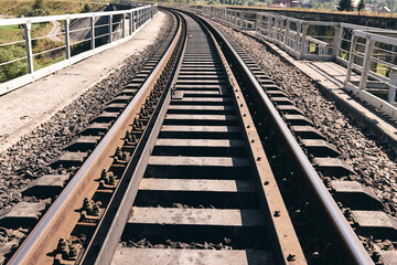 Train rails in country landscape. Railroad tracks at sunset time. Local travel concept