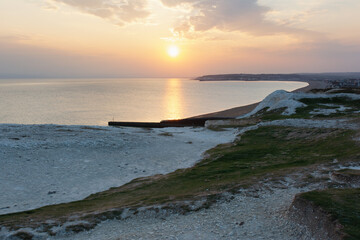 Seaford, East Sussex, England. View of the white chalk cliffs to the west in the evening sunset, part of Seven Sisters National park, selective focus