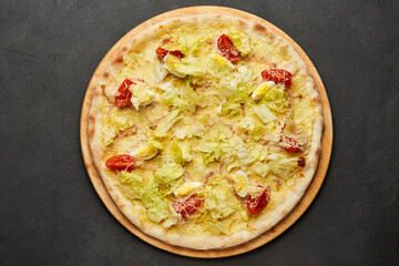 Delicious Italian pizza Caesar on dark background