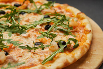 Delicious Italian seafood pizza on dark background