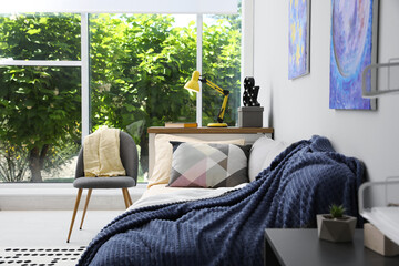 Modern teenager's room interior with comfortable bed and stylish design elements