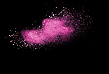 Pink powder explosion on black background. Paint Holi.