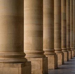Historical round shaped sandstone pillar in a row close up
