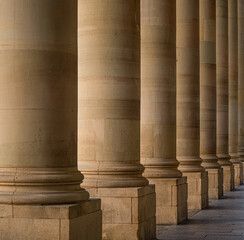 Historical round shaped sandstone pillar in a row close up