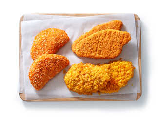 Raw Breaded Chicken Schnitzel Slices in a studio setting, isolated on white