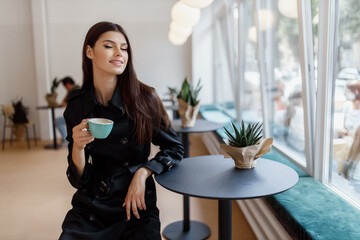 beautiful girl in a coffee shop with a cup of coffee