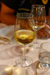 Two glasses of cold dry white wine served outdoor in cafe at night in Italy