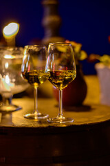 Two glasses of cold dry white wine served outdoor in cafe at night in Italy