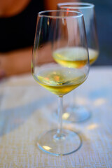 Two glasses of cold dry white wine served outdoor in cafe at night in Italy