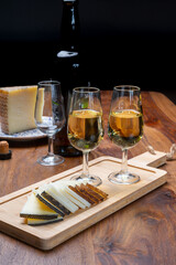 Spanish fino sherry wine from Andalusia and pieces of different sheep hard manchego cheeses made in La Mancha, Spain. Wine and cheese pairing