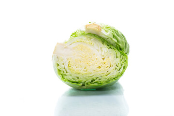 early green cabbage cut in half swing on a white background