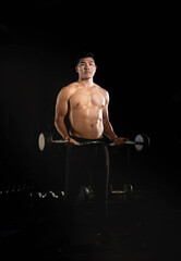 Fototapeta na wymiar Handsome man lifting Barbell,doing exercise for buit muscle,fit and firm body