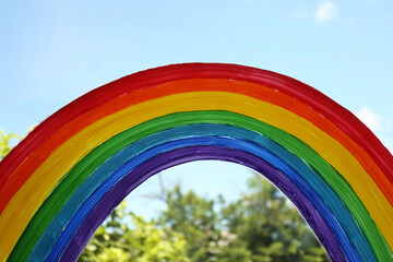 Obraz premium Painting of rainbow on window, closeup. Stay at home concept