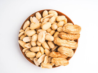 Peanuts in a wooden bowl on white background