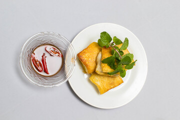 fried tofu blocks and fish sauce on white background