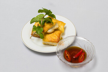 fried tofu blocks and fish sauce on white background