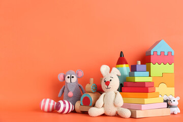 Set of different toys on orange background. Space for text