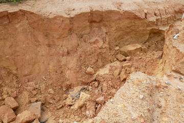 Erosion at ground and slopes is caused by rainfall. The soil structure is weak and there are landslide. Safety measure has been taken in some area.