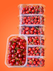 Packaged cherries in a studio setting, isolated on white