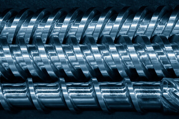 Close-up scene of injection machine screw spare parts.  the injection machine manufacturing process concept.