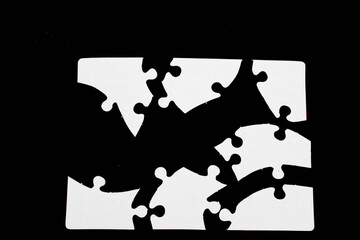 white puzzle pieces on black background