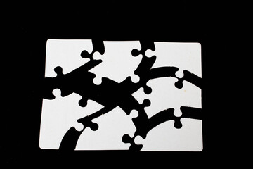 white puzzle pieces on black background