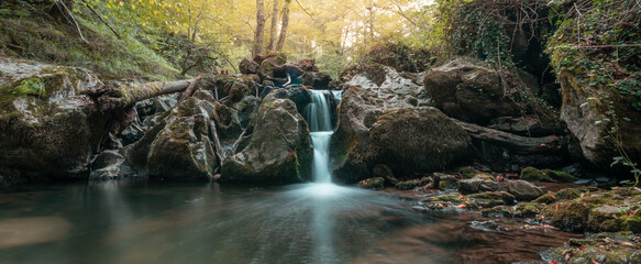 View of a waterfall with moss-covered rocks